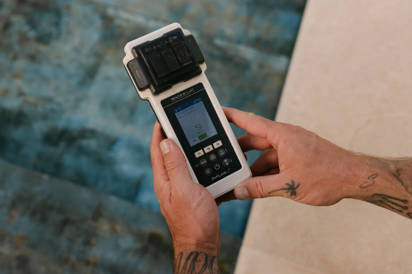 Measuring pool water values with a photometer at the pool edge